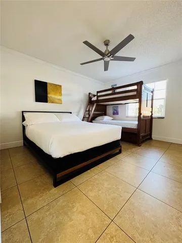 a bedroom with a bed and ceiling fan
