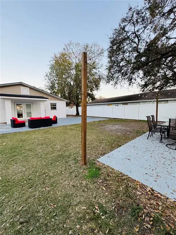 a view of pool with lawn chairs and wooden fence