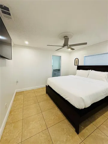 a bedroom with a bed and a night stand