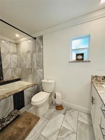 a bathroom with a toilet a sink and a shower