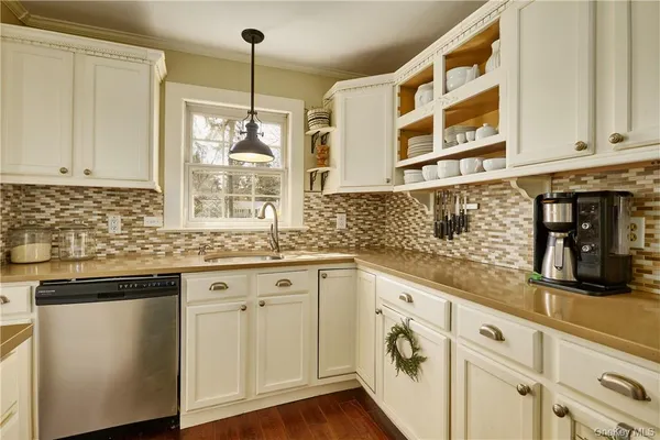 a kitchen with granite countertop white cabinets and white appliances