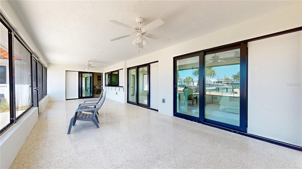 6380 3rd Palm Point St. Pete Beach, FL 33706 - Photo 14 of 48 a view of an empty room with wooden floor and a window
