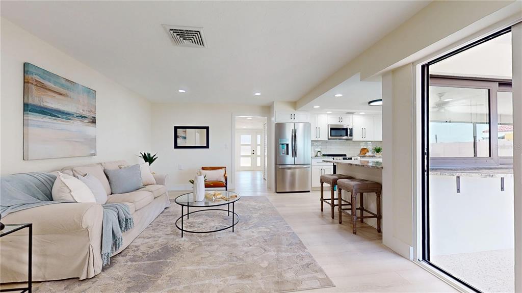 6380 3rd Palm Point St. Pete Beach, FL 33706 - Photo 15 of 48 a living room with furniture and kitchen view