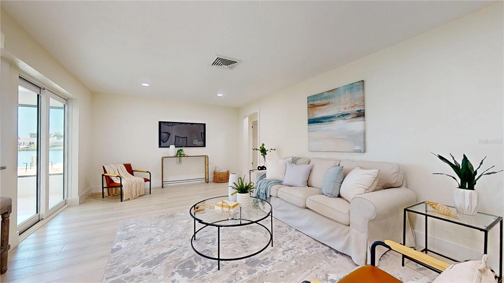 6380 3rd Palm Point St. Pete Beach, FL 33706 - Photo 17 of 48 a living room with furniture and a flat screen tv