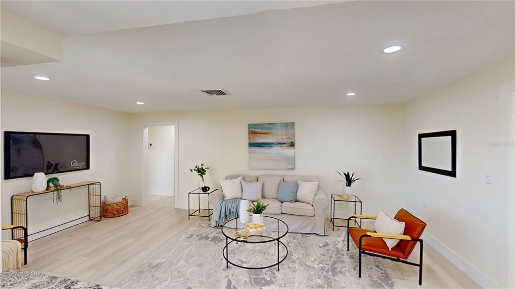 6380 3rd Palm Point St. Pete Beach, FL 33706 - Photo 19 of 48 a living room with furniture and a flat screen tv