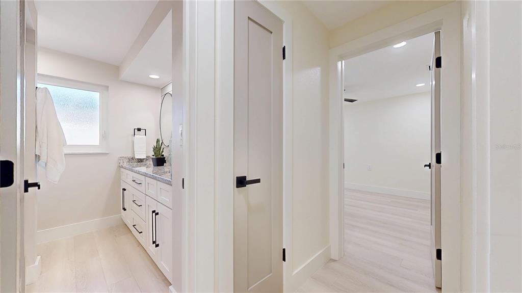 6380 3rd Palm Point St. Pete Beach, FL 33706 - Photo 21 of 48 a bathroom with a double vanity sink and mirror