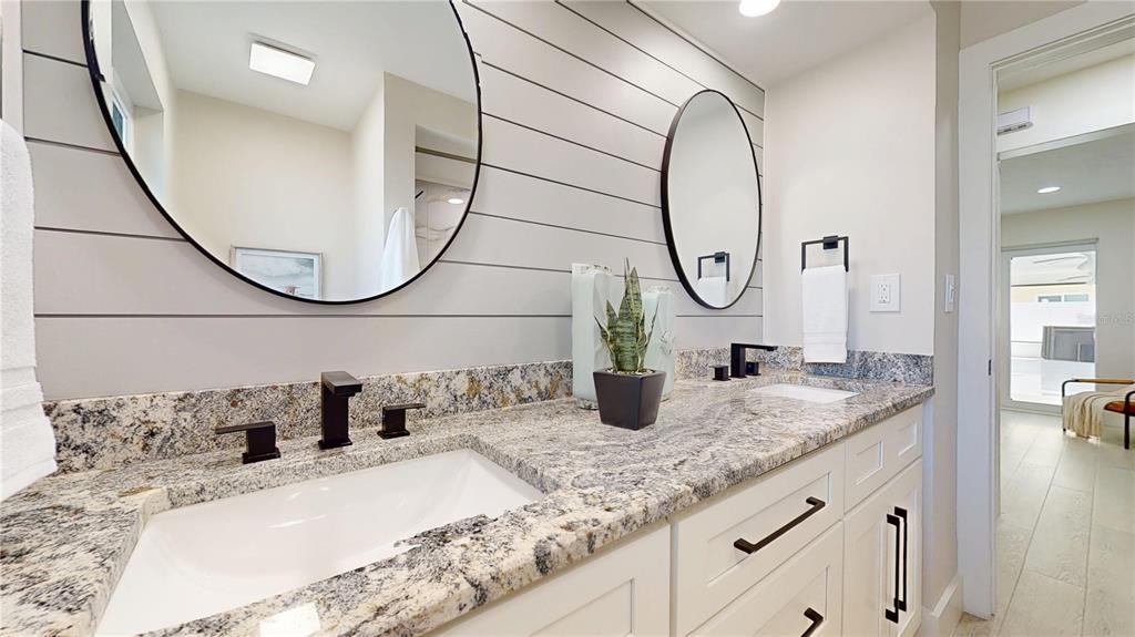 6380 3rd Palm Point St. Pete Beach, FL 33706 - Photo 23 of 48 a bathroom with a granite countertop sink and a mirror