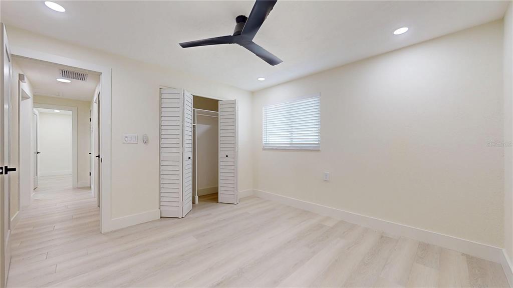 6380 3rd Palm Point St. Pete Beach, FL 33706 - Photo 24 of 48 an empty room with wooden floor and windows
