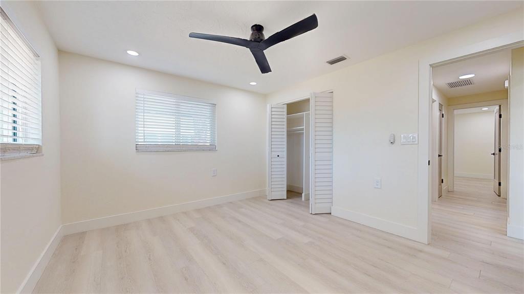 6380 3rd Palm Point St. Pete Beach, FL 33706 - Photo 26 of 48 wooden floor in an empty room with a window