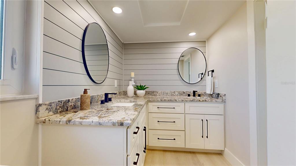 6380 3rd Palm Point St. Pete Beach, FL 33706 - Photo 30 of 48 a bathroom with a sink vanity and a mirror