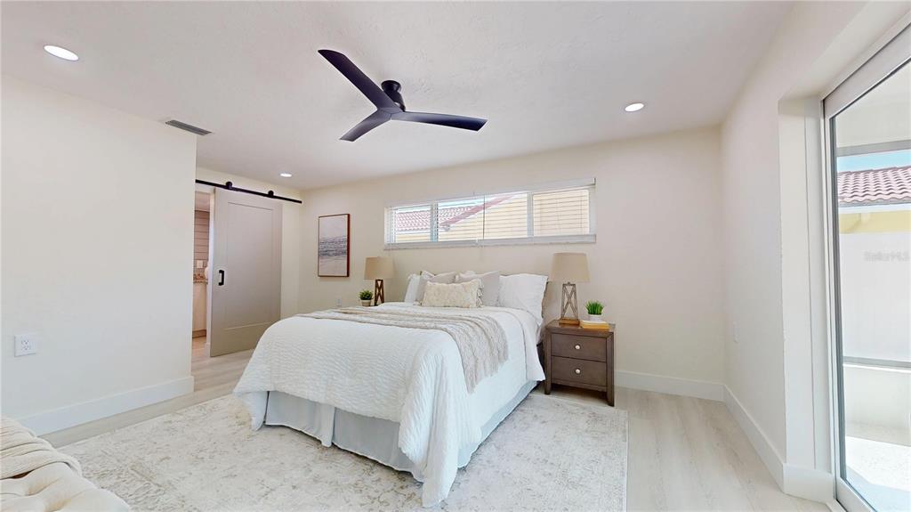 6380 3rd Palm Point St. Pete Beach, FL 33706 - Photo 32 of 48 a bedroom with a bed and a window