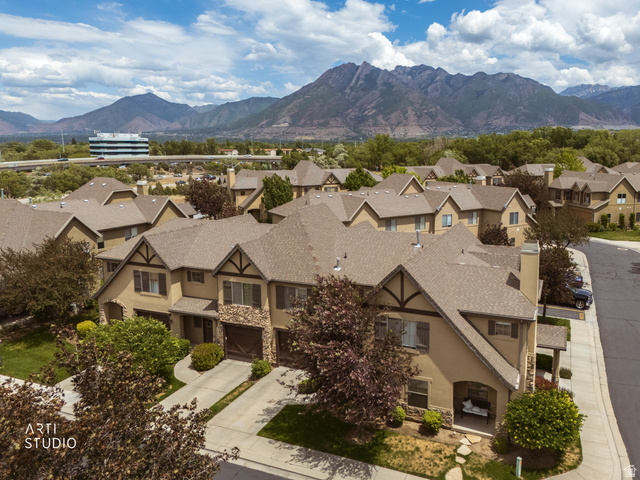 6761 950 East Midvale, UT 84047 - Photo 35 of 44 Residential community featuring multiple townhomes with earth-toned exteriors, stone accents, and gabled roofs