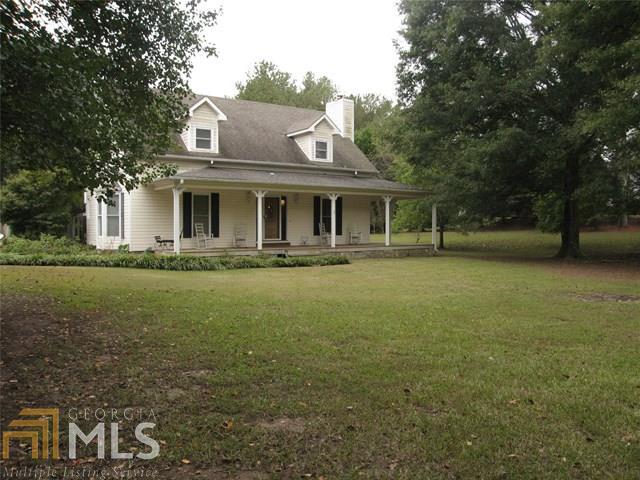 a front view of house with yard and trees