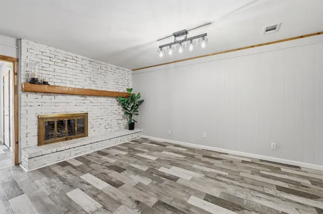 a view of empty room with a fireplace