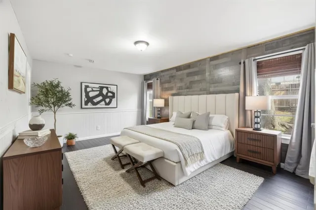 a bedroom with a large bed and a window