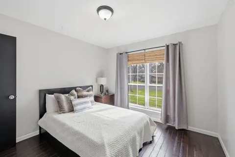 a bedroom with a bed and a large window