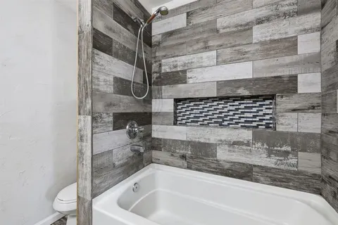 a bathroom with a bathtub and shower