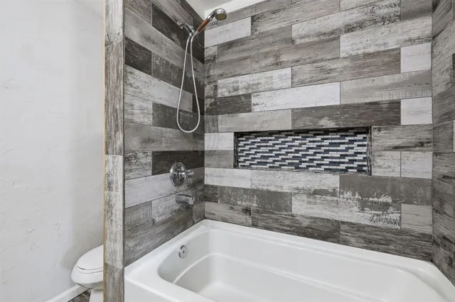 a bathroom with a bathtub and shower