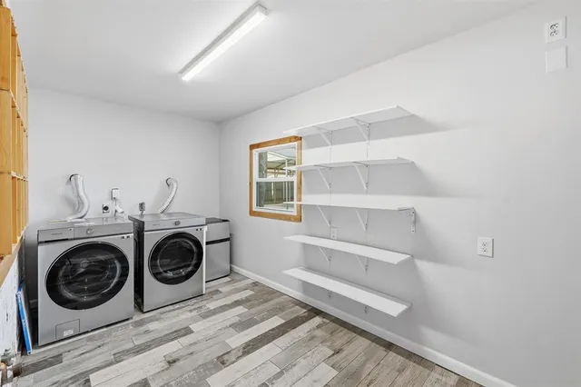 a utility room with sink dryer and washer