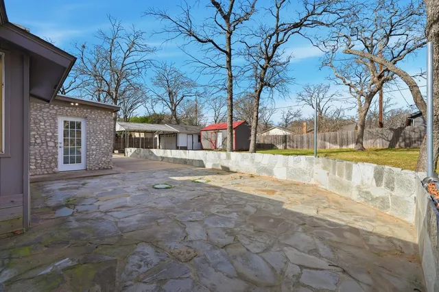 a view of residential houses with yard and tree