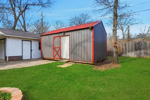 a backyard of a house with lots of green space and outdoor seating
