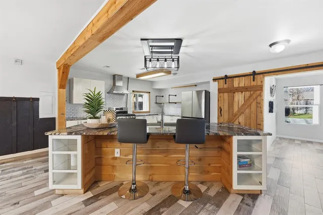 a view of a livingroom with furniture window and wooden floor