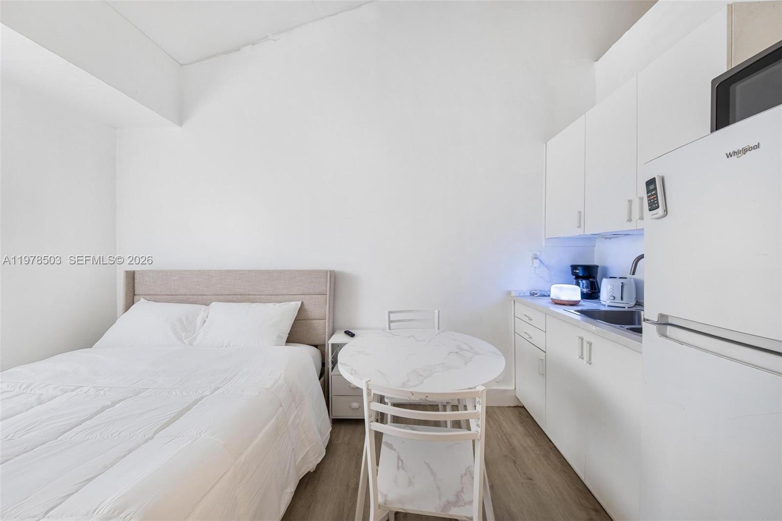 2520 Southwest 20th Street, Unit 1 Miami, FL 33145 - Photo 11 of 16 a bedroom with a bed and a table in it