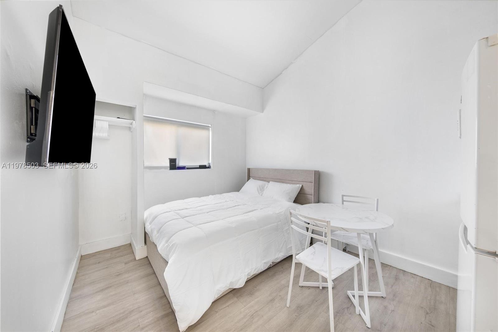 2520 Southwest 20th Street, Unit 1 Miami, FL 33145 - Photo 10 of 16 a bedroom with a bed and a flat screen tv