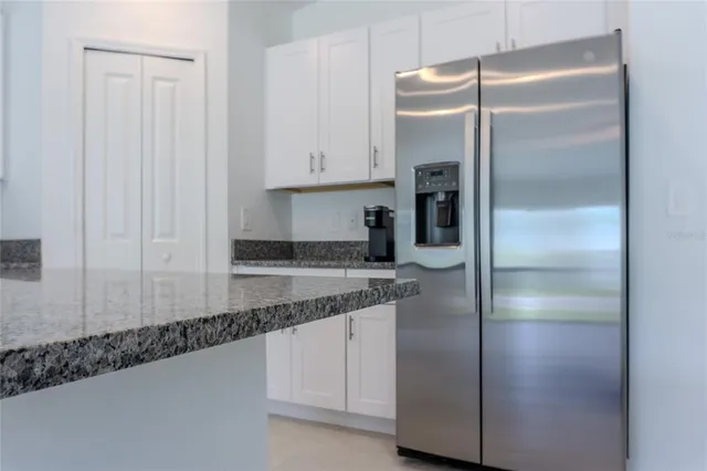 a kitchen with stainless steel appliances granite countertop a stove and a microwave