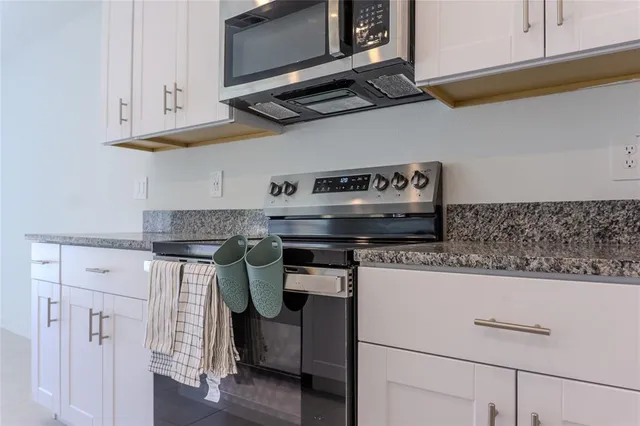 a kitchen with appliances a sink and cabinets