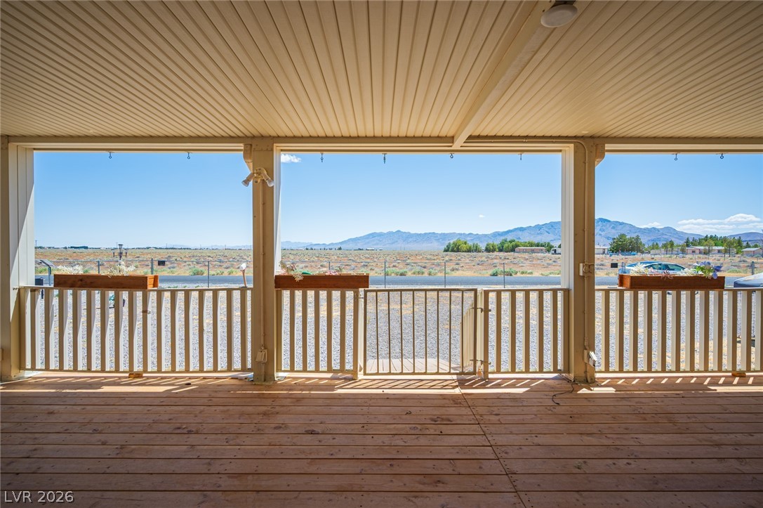 3200 Maple Road Pahrump, NV 89048 - Photo 7 of 53 Relax on the covered deck, enjoying the sweeping mountain views and peaceful desert landscape.