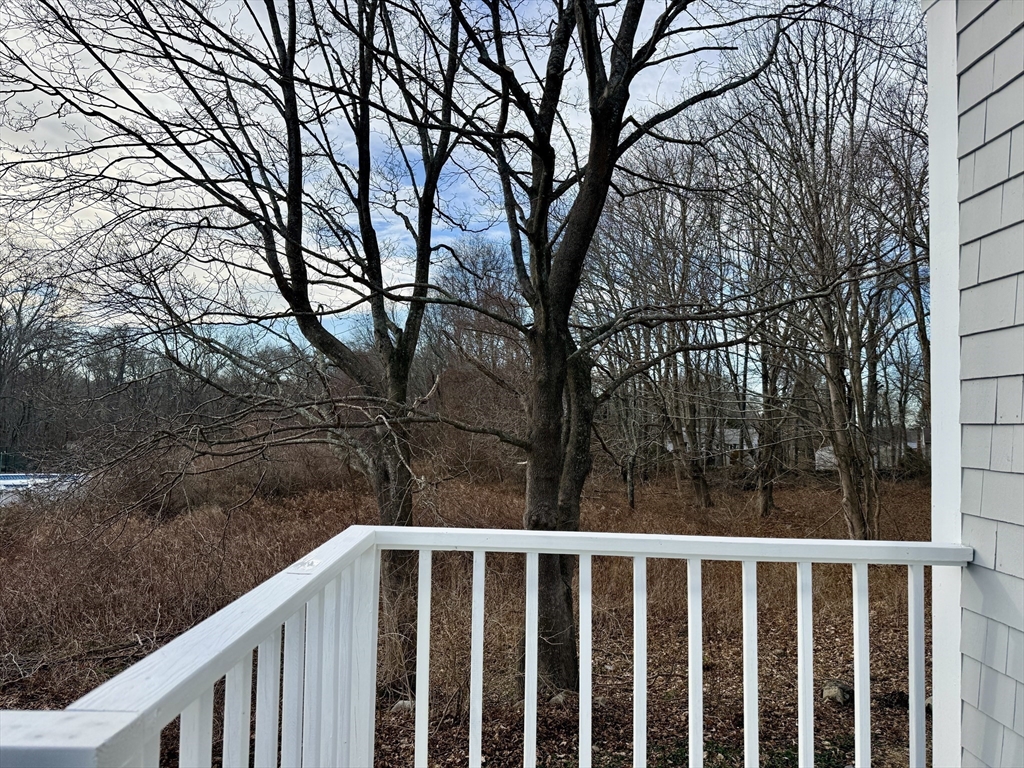 513 Slocum Road Dartmouth, MA 02747 - Photo 12 of 34 a view of a wooden deck next to a yard