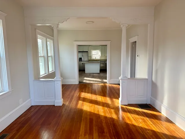 a living room with a bed furniture and a window