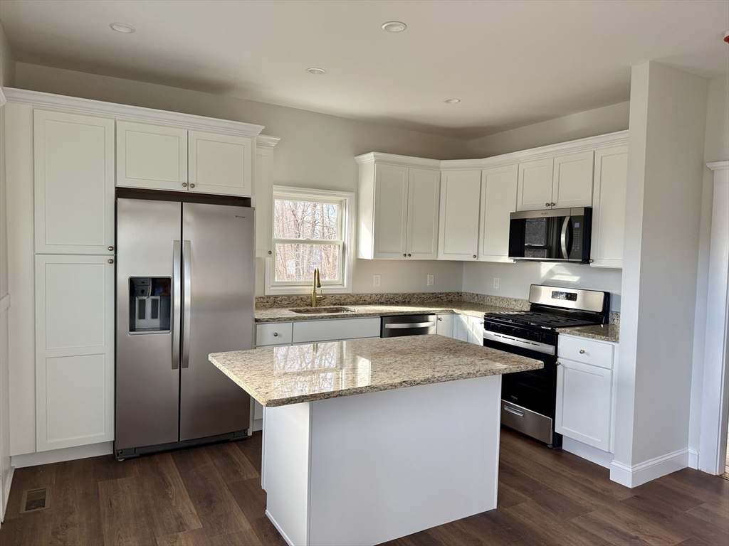 513 Slocum Road Dartmouth, MA 02747 - Photo 16 of 34 a kitchen with granite countertop a refrigerator and a stove top oven