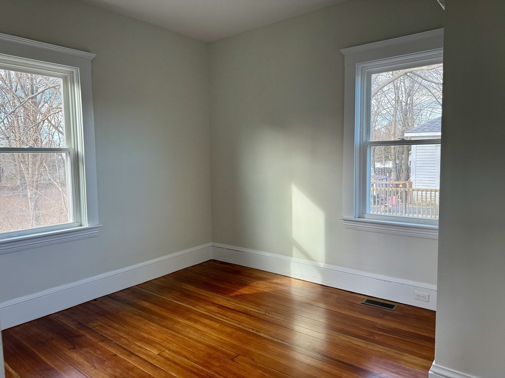 513 Slocum Road Dartmouth, MA 02747 - Photo 23 of 34 an empty room with wooden floor and windows