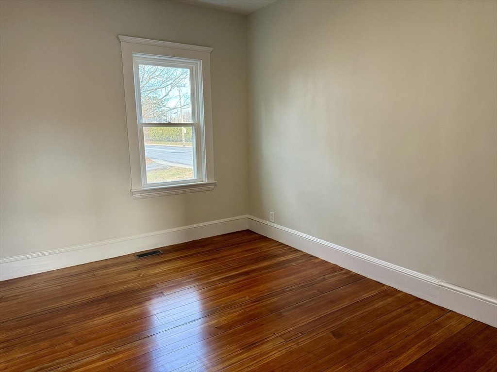 513 Slocum Road Dartmouth, MA 02747 - Photo 24 of 34 a view of an empty room with wooden floor and a window
