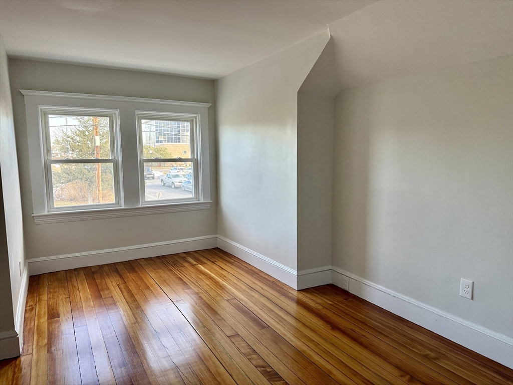 513 Slocum Road Dartmouth, MA 02747 - Photo 30 of 34 an empty room with wooden floor and windows
