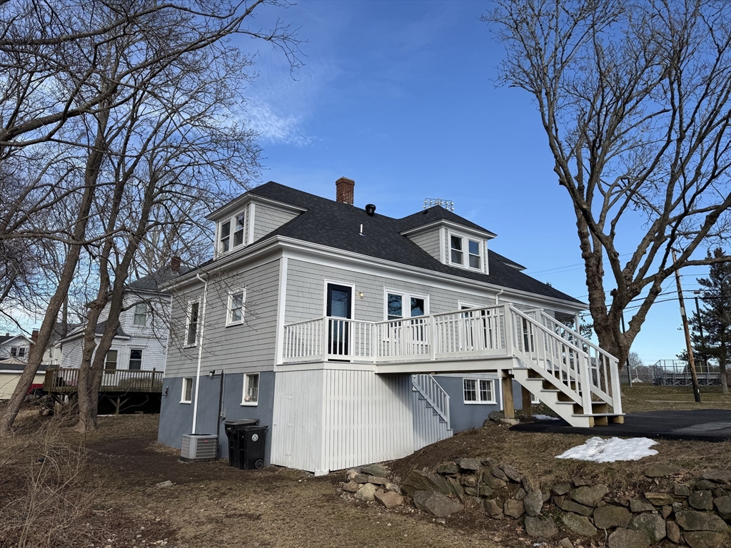 513 Slocum Road Dartmouth, MA 02747 - Photo 7 of 34 a view of a white house with a large tree