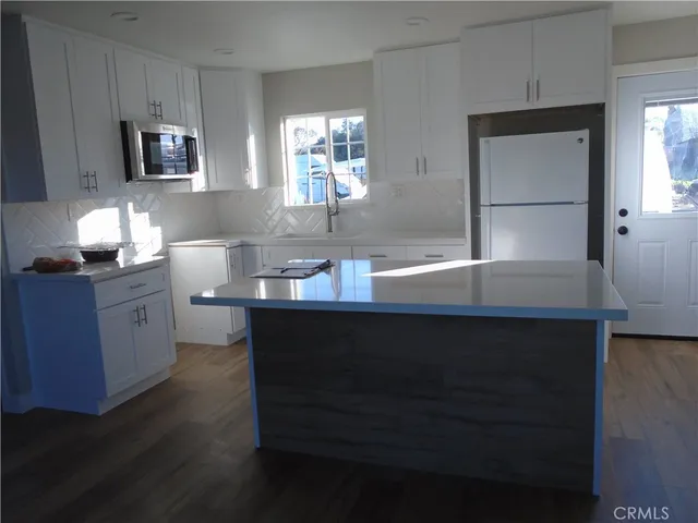 a living room with furniture and large windows