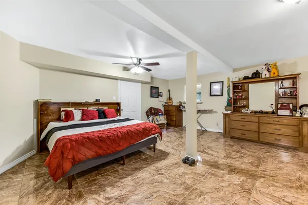 a bedroom with a bed and dresser