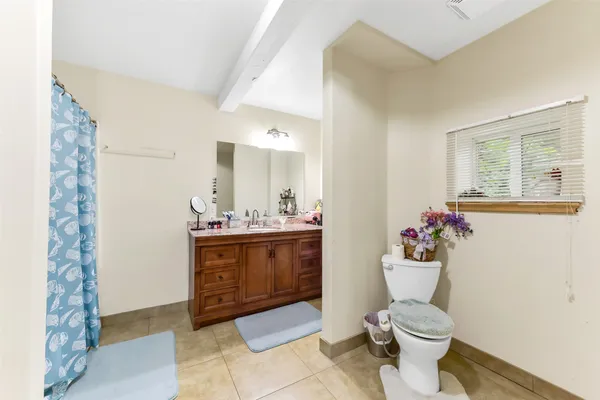 a bathroom with a toilet a sink and a mirror