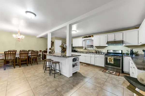 a kitchen with cabinets and chairs