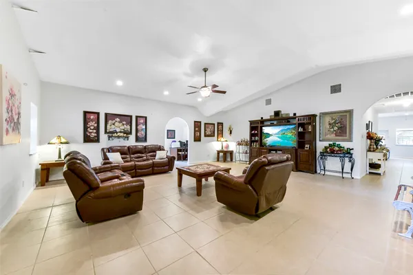 a view of a dining room with furniture and a chandelier