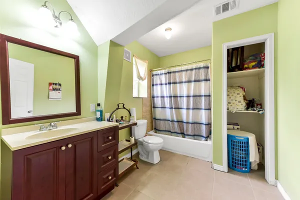 a bedroom with a bed a table and chairs