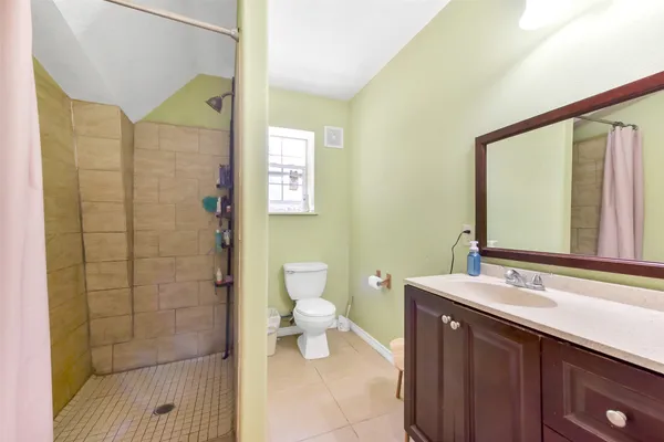a bathroom with a toilet a sink and mirror