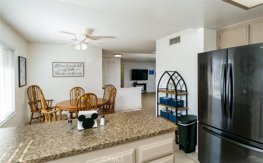 27062 Terrytown Road Menifee, CA 92586 - Photo 16 of 36 a view of a kitchen with a dining table and chairs