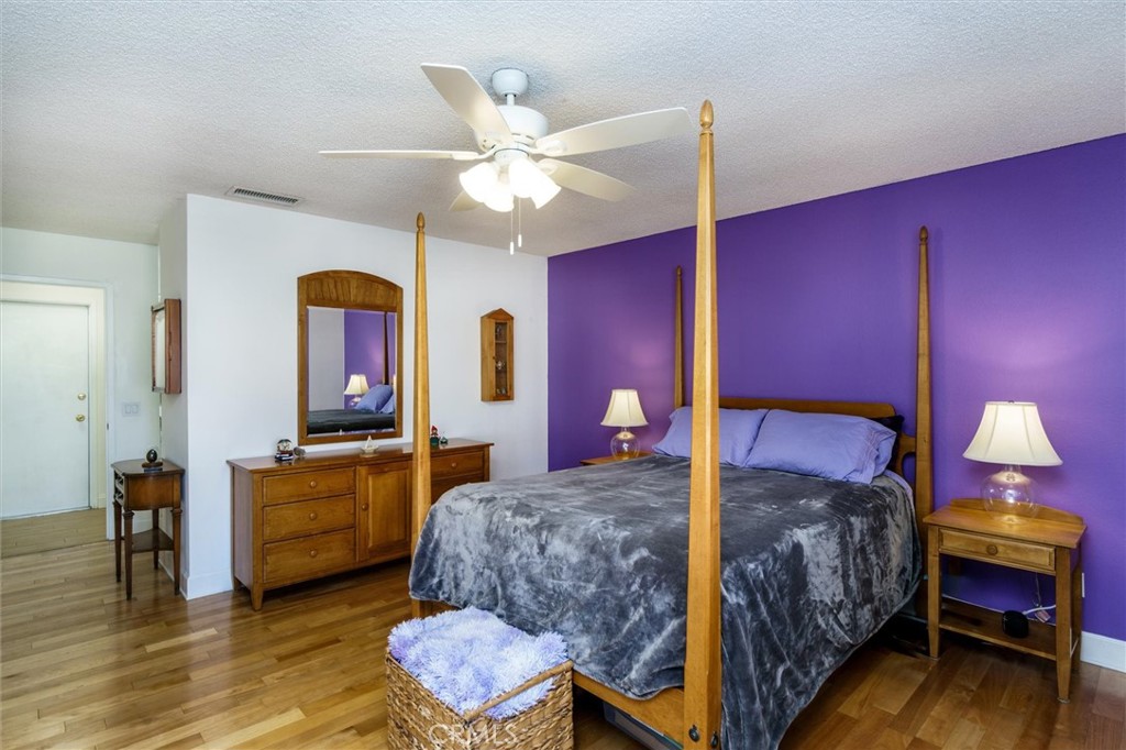 27062 Terrytown Road Menifee, CA 92586 - Photo 17 of 36 a bedroom with a bed and a chandelier