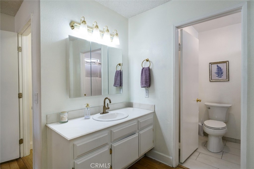 27062 Terrytown Road Menifee, CA 92586 - Photo 19 of 36 a bathroom with a toilet sink and mirror