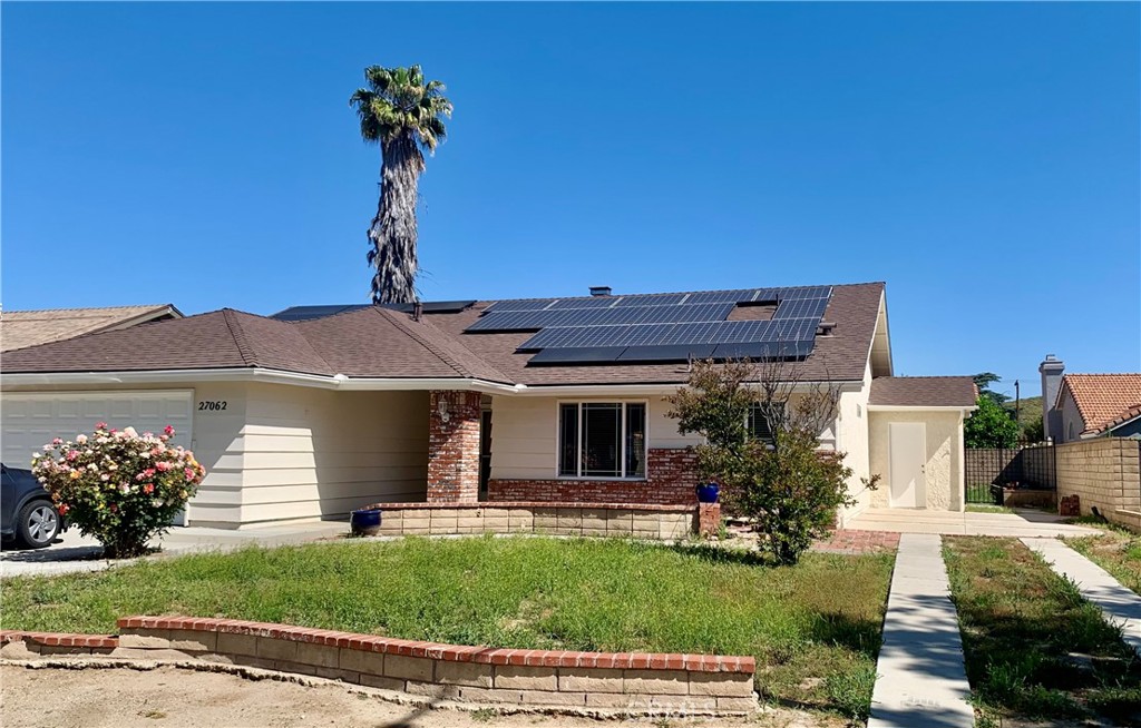 27062 Terrytown Road Menifee, CA 92586 - Photo 2 of 36 a front view of a house with a garden