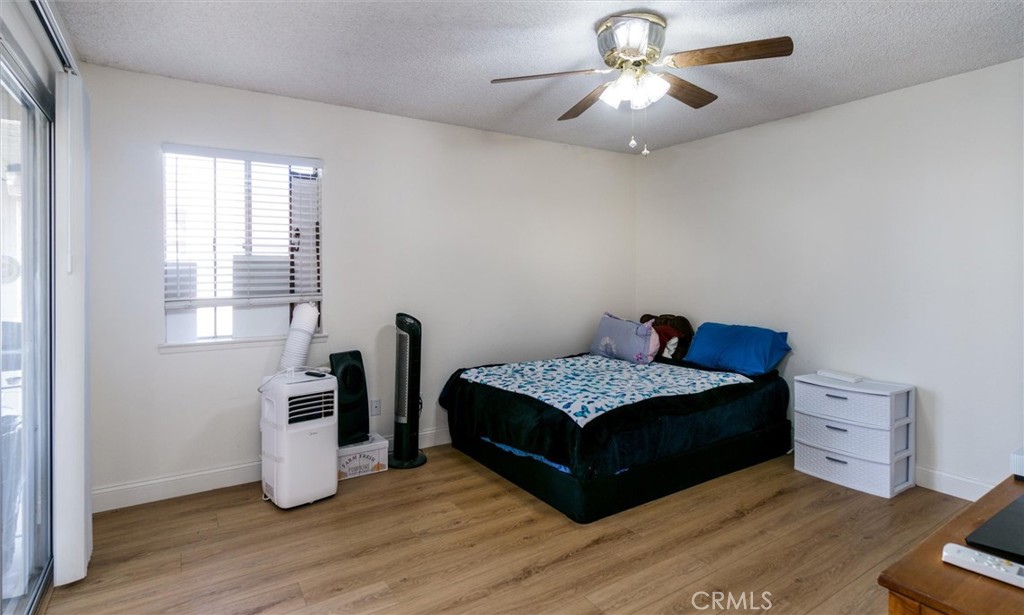 27062 Terrytown Road Menifee, CA 92586 - Photo 21 of 36 a bedroom with a bed and a chandelier